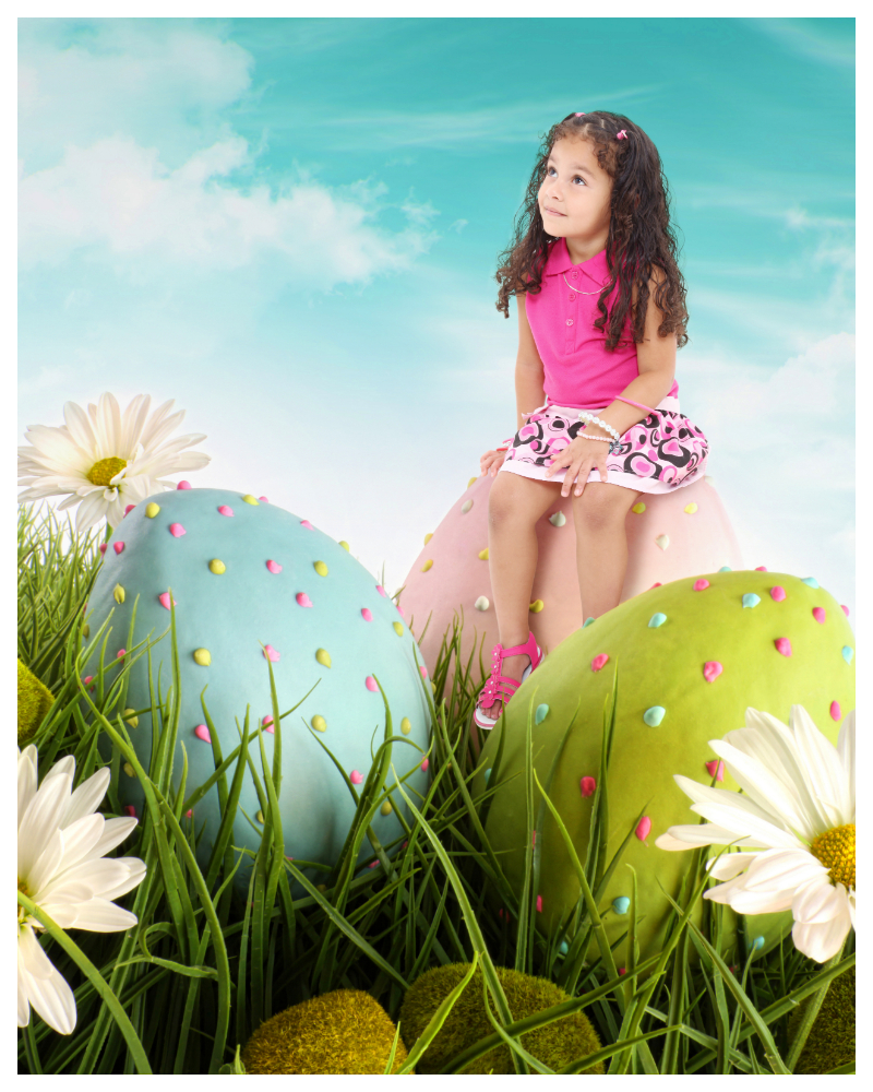 Easter photo of girl sitting on top of large eggs